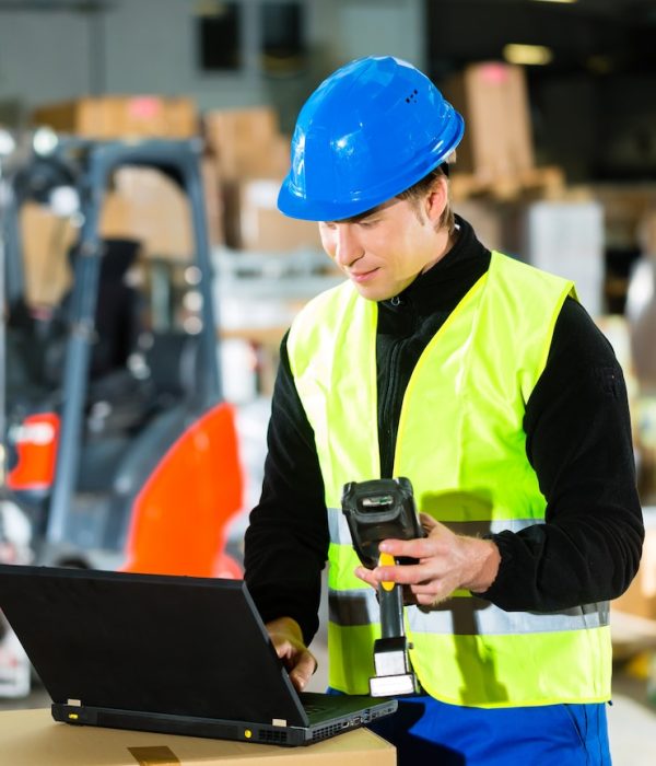 warehouseman-with-protective-vest-scanner-laptop-warehouse-freight-forwarding-company_79405-10213